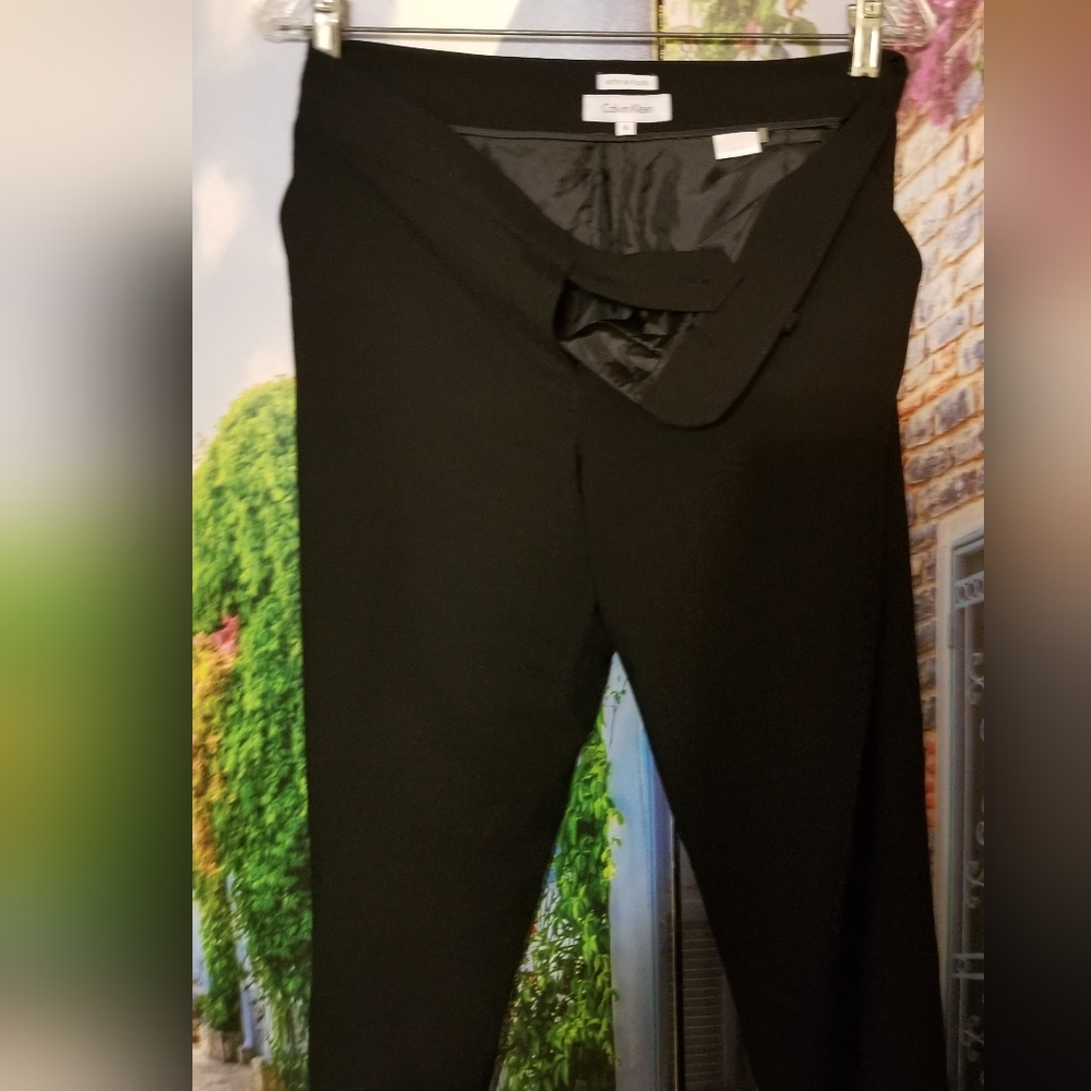 Calvin Klein straight leg Pants. Black with pockets zippered strap on waist.